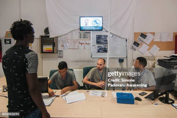 An asylum seeker watches the introductory video that explains the basic laws and rules of the centre and provides them with other useful information...