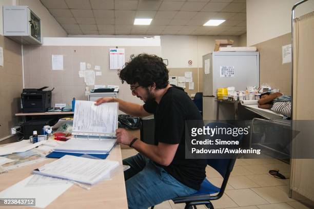 Member of the CARA Hub medical staff checks the data of an asylum seeker on July 27, 2017 in Bologna, Italy. In an effort to address the...