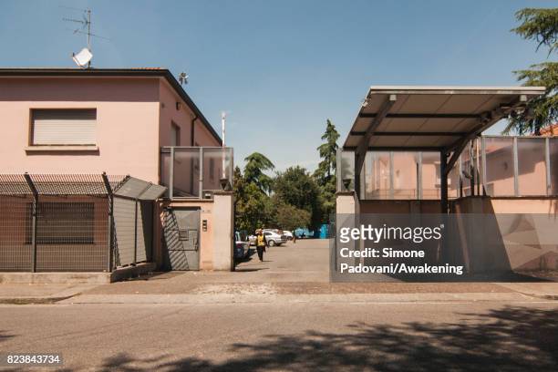 Member of staff walks to the offices at the entrance of Hub CARA on July 27, 2017 in Bologna, Italy. In an effort to address the over-crowding,...