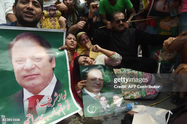 Activists of Pakistan Muslim League Nawaz protest the Supreme Court decision against Prime Minister Nawaz Sharif, in Lahore on July 28, 2017....