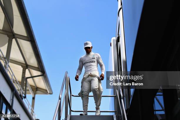 Lewis Hamilton of Great Britain and Mercedes GP walks to the garage before practice for the Formula One Grand Prix of Hungary at Hungaroring on July...