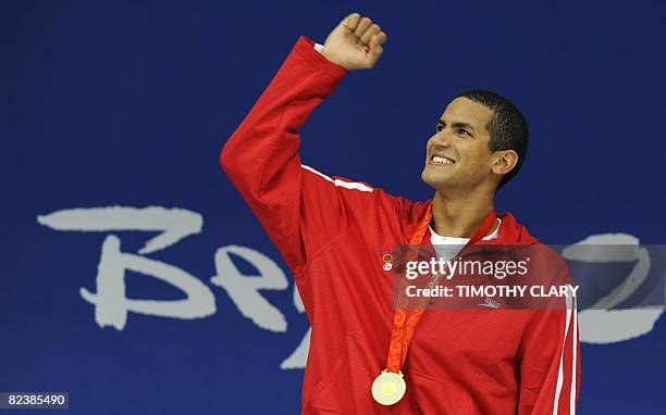 Oussama Mellouli of Tunisia stands on the podium for the men's 1500m freestyle swimming final medal ceremony at the National Aquatics Center during...