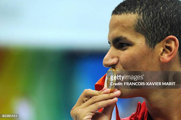 Oussama Mellouli of Tunisia poses after the men's 1500m freestyle swimming final medal ceremony at the National Aquatics Center during the 2008...