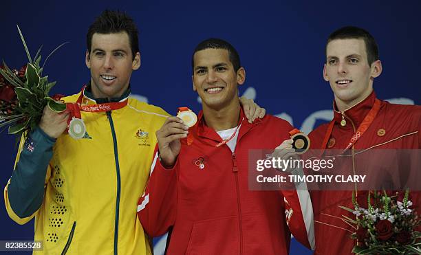 Gold medalist Tunisia's Oussama Mellouli , silver medalist Australia's Grant Hackett and bronze medalist Canada's Ryan Cochrane stands on the podium...