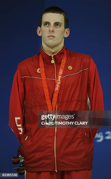 Bronze medalist Canada's Ryan Cochrane stands on the podium after the men's 1500m freestyle swimming final medal ceremony at the National Aquatics...