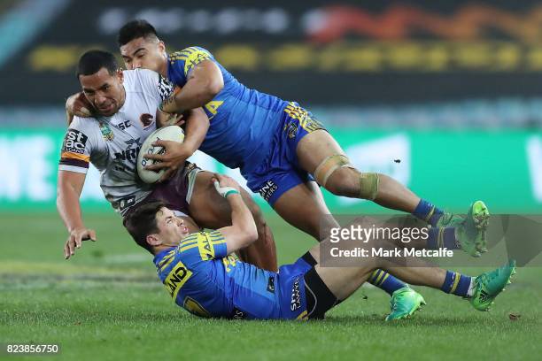 Tautau Moga of the Broncos is tackled during the round 21 NRL match between the Parramatta Eels and the Brisbane Broncos at ANZ Stadium on July 28,...