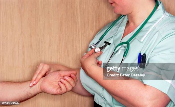 senior man having blood pressure health check by nurse - heart beat stock pictures, royalty-free photos & images