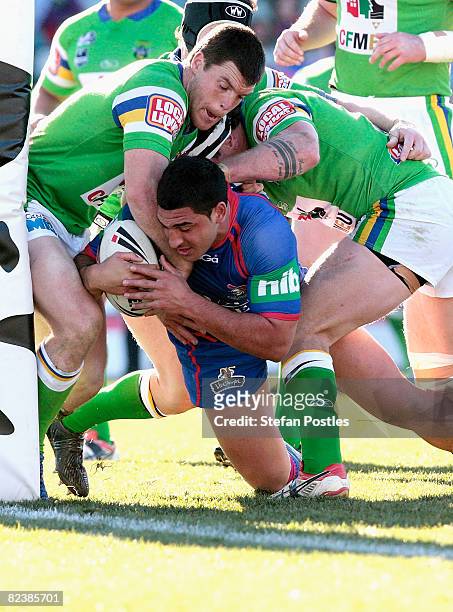 Raiders defence is too strong for Marvin Karawana of the Knights during the round 23 NRL match between the Canberra Raiders and the Newcastle Knights...