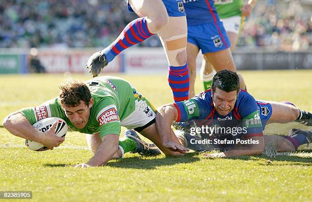 Terry Campese of the Raiders scores a try during the round 23 NRL match between the Canberra Raiders and the Newcastle Knights at Canberra Stadium on...