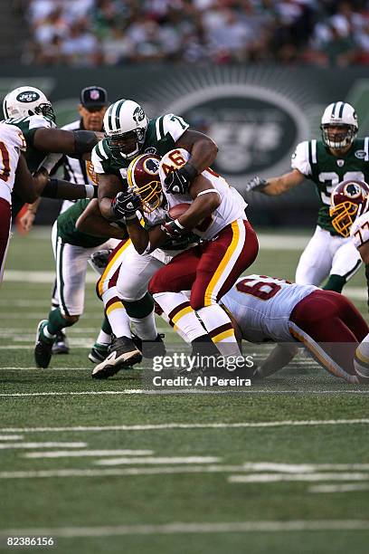 Defensive Tackle Kris Jenkins of the New York Jets stops Runing Back Ladell Betts of the Washington Redskins as the Jets host the Washington Redskins...