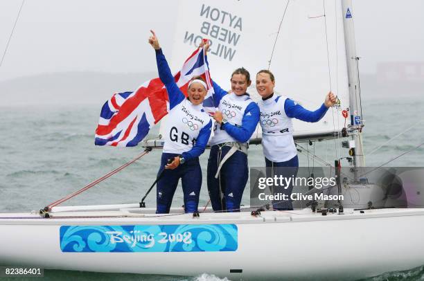 Sarah Ayton, Sarah Webb and Pippa Wilson of Great Britain celebrate overall victory following the Yngling class medal race held at the Qingdao...