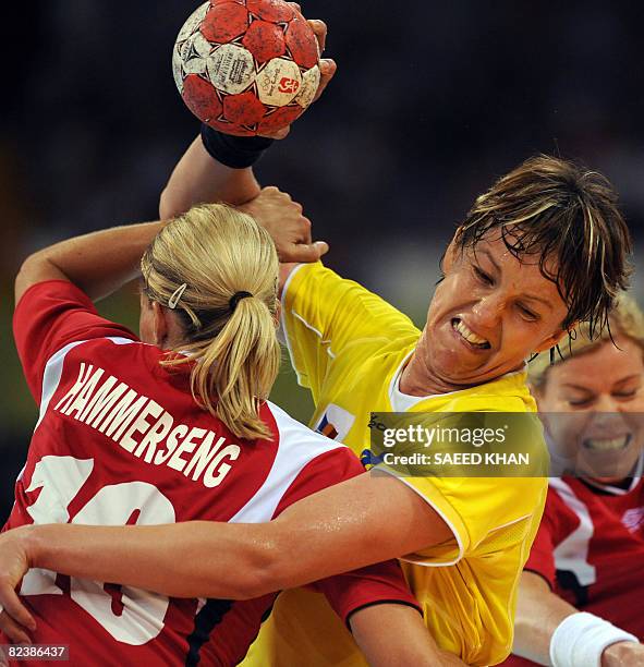 Gro Hammerseng of Norway challenges Valeria Bese of Romania during their 2008 Beijing Olympic Games Women's handball match on August 16, 2008. Norway...