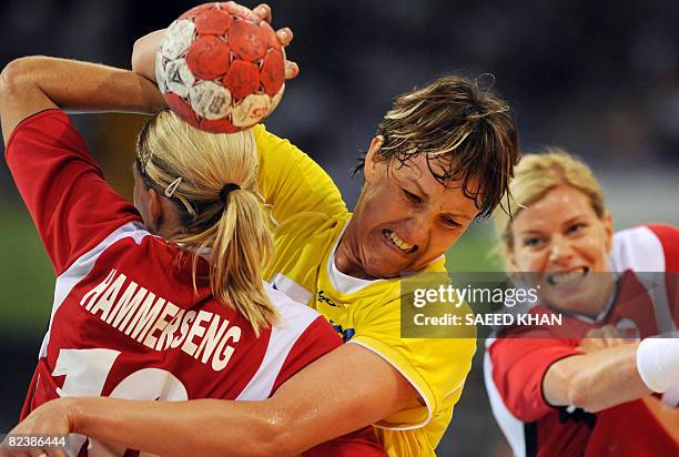 Gro Hammerseng of Norway challenges Valeria Bese of Romania during their 2008 Beijing Olympic Games Women's handball match on August 16, 2008. Norway...