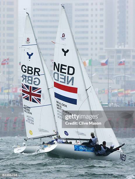 Sarah Ayton, Sarah Webb and Pippa Wilson of Great Britain and Mandy Mulder, Annemieke Bes and Merel Witteveen of Netherlands compete in the Yngling...