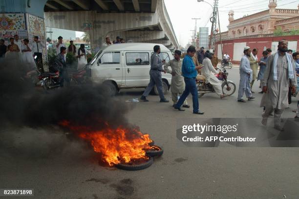 Activists of Pakistan Muslim League Nawaz burn tyres to protest after the Supreme Court decision against Pakistan's Prime Minister Nawaz Sharif in...