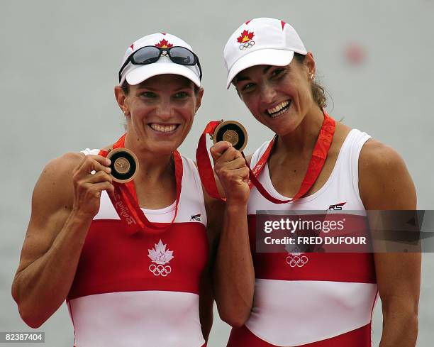 2nd CORRECTION-SILVER TO BRONZE Canada's Melanie Kok and Tracy Cameron hold their bronze medals during the medal ceremony in the lightweight women's...