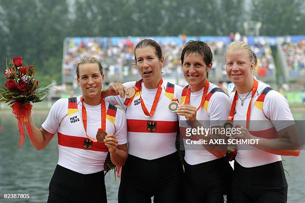 Germany's Britta Oppelt, Manuela Lutze, Kathrin Boron and Stephanie Schiller pose of the podium of the women's quadruple sculls at the Shunyi Rowing...