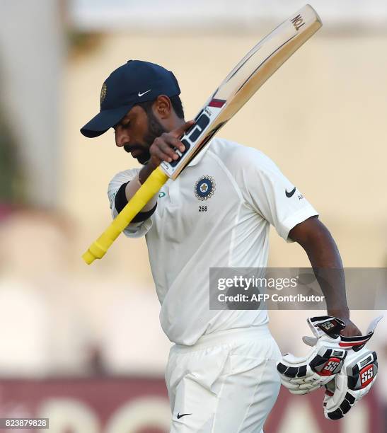 Indian batsman Abhinav Mukund leaves the pitch after being dismissed during the third day of the first Test match between Sri Lanka and India at...