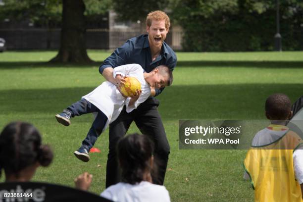 Prince Harry plays with children during a visit to StreetGames' Fit and Fed at Central Park East Ham on July 28, 2017 in London, England. The session...