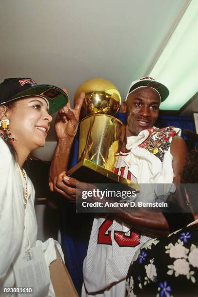 Michael Jordan of the Chicago Bulls celebrates with the Larry O'Brien Trophy after defeating the Portland Trail Blazers in Game Six of the NBA Finals...