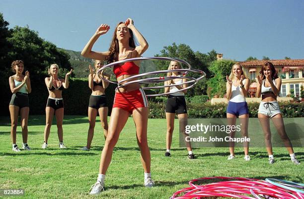 Model Vanessa Norris hoola hoops as her teammates cheer her on during the Perfect 10 Magazine model of the year competition June 13, 1998 in Santa...