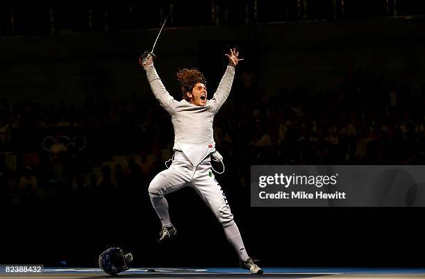 Aldo Montano of Italy celebrates his team sabre fencing bronze medal win over Stanislav Pozdnyakov of Russia at the Fencing Hall of National...