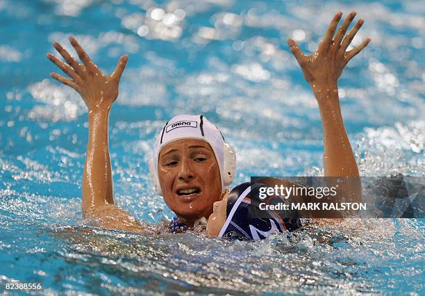 Cinzia Ragusa of Italy tries to shoot for goal but as Yasemin Smit from the Netherlands during their women's quarterfinal water polo match at the...