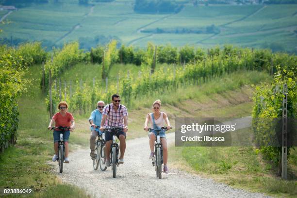 family holidays in langhe region, piedmont, italy: electric bikes trip in the hills - agritourism stock pictures, royalty-free photos & images