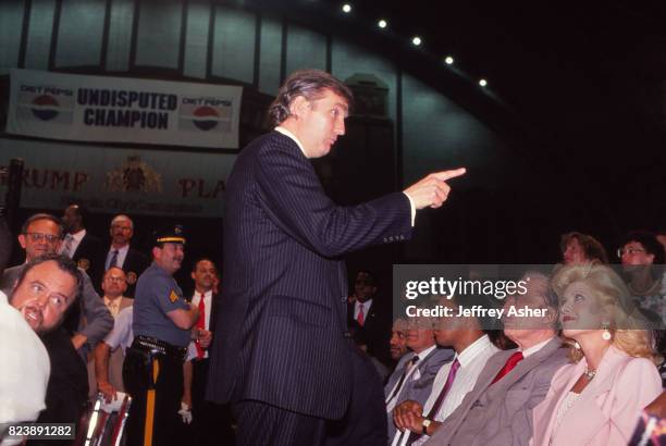 Businessman Donald Trump and first wife Ivana Father Fred Trump and Champion Boxer Muhammad Ali ringside at Tyson vs Holmes Convention Hall in...