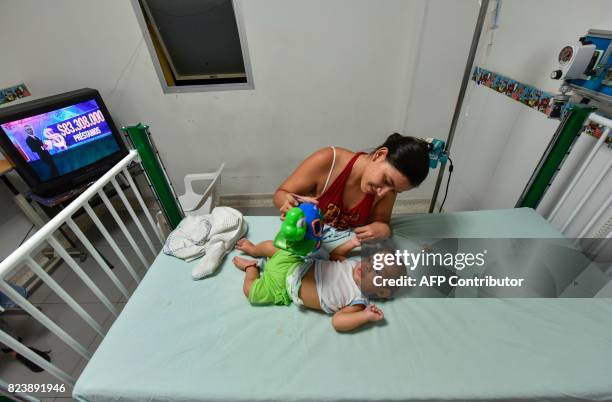 Venezuelan national Yelitza Viera plays with her baby at the Erasmo Meoz University Hospital in Cucuta, North of Santander department, Colombia on...