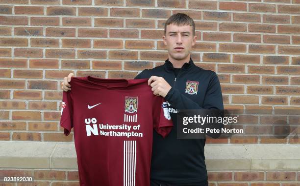 Northampton Town new signing Chris Long poses with a shirt during a photo call at Sixfields on July 28, 2017 in Northampton, England.