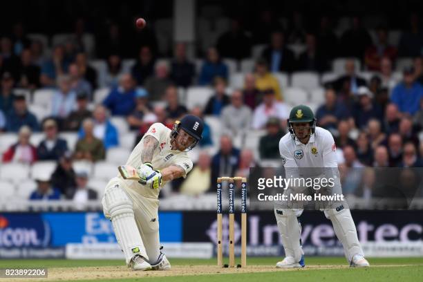 Ben Stokes of England smashes a six to bring up his century as Quinton De Kock of South Africa looks on during Day Two of the 3rd Investec Test match...