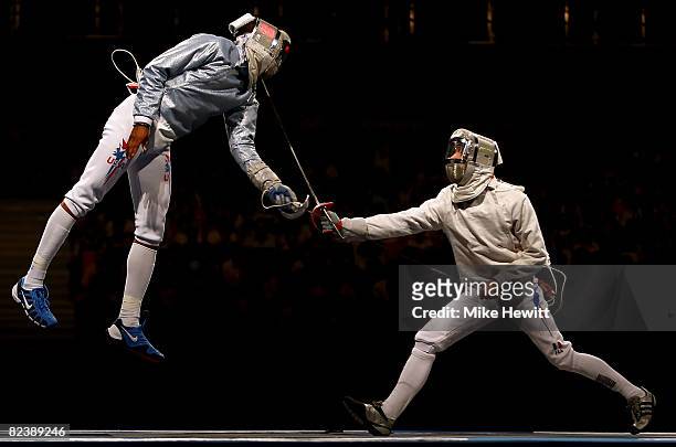 Nicolas Lopez of France and Keeth Smart of the United States compete in the men's team sabre fencing gold medal match at the Fencing Hall of National...