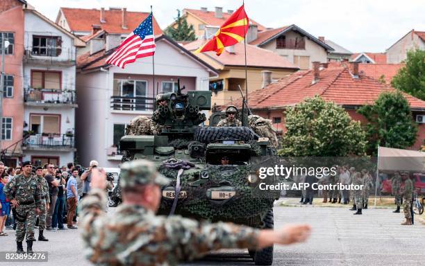 Soldiers arrive on a tank during the presentation of their vehicles and weapons in Kumanovo on July 28, 2017. Some 300 US soldiers, accompanied by 95...