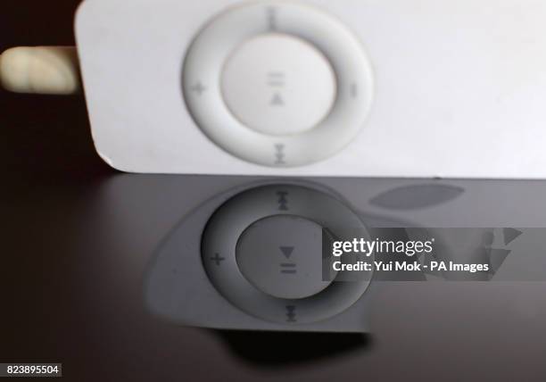 1st Generation iPod Shuffle music player reflected in an Apple logo in London, after Apple announced plans to discontinue the iPod nano and shuffle...