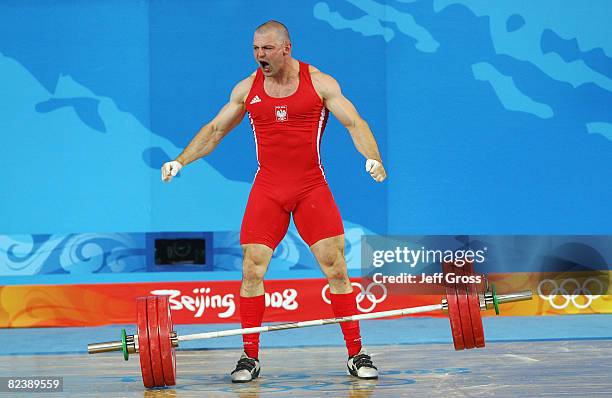 Szymon Kolecki of Poland celebrates after a successful lift in the men's 94kg weightlifting event held at the Beijing University of Aeronautics &...