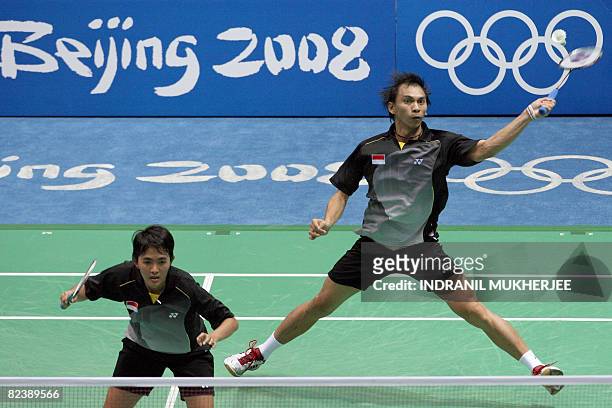 Flandy Limpele and Vita Marissa of Indonesia play against He Hanbin and partner Yu Yang of China in the mixed doubles bronze medal play-off badminton...