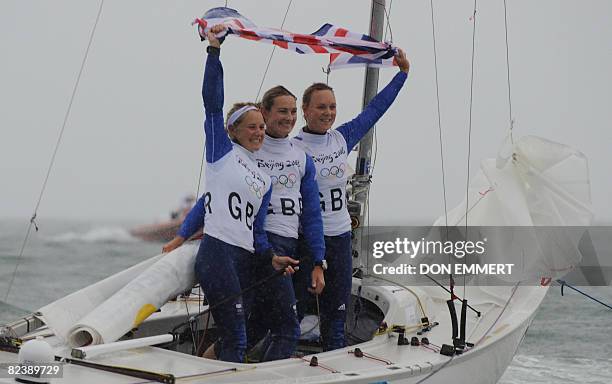 Sailors Sarah Ayton, Sarah Webb and Pippa Wilson of Great Britain celebrate their gold medal win race in the Ygling class in the 2008 Beijing Olympic...