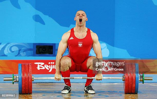 Szymon Kolecki of Poland attempts a successful lift in the men's 94kg weightlifting event held at the Beijing University of Aeronautics &...