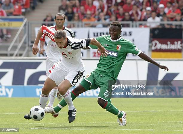 Marek Mintal of Nuernberg and A. Sinkala of Augsburg battle for the ball during the 2nd Bundesliga match between 1. FC Nuernberg and FC Augsburg on...