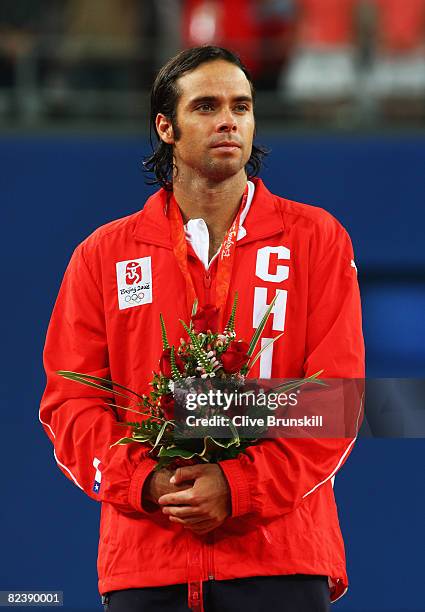 Silver medalist Fernando Gonzalez of Chile looks on after the men's singles gold medal tennis match held at the Olympic Green Tennis Center during...