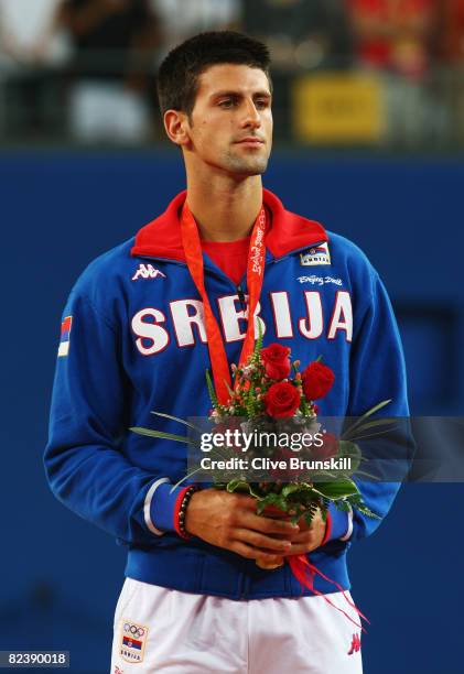 Bronze medalist Novak Djokovic of Serbia looks on after the men's singles gold medal tennis match held at the Olympic Green Tennis Center during Day...