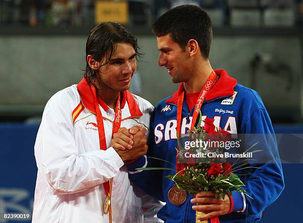 Gold medalist Rafael Nadal of Spain is congratulated by bronze medalist Novak Djokovic of Serbia after the men's singles gold medal tennis match held...