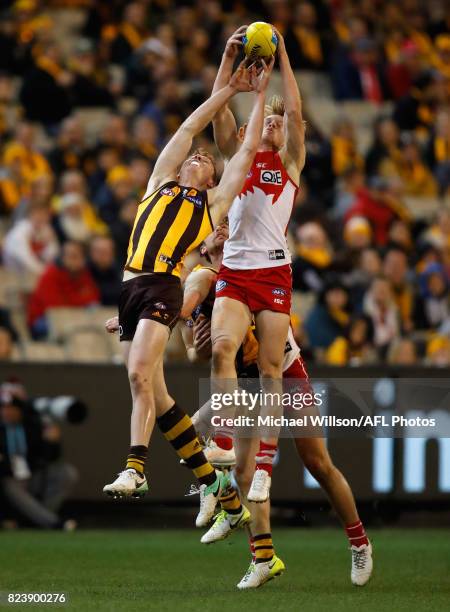 Tim O'Brien of the Hawks and Callum Mills of the Swans compete for the ball during the 2017 AFL round 19 match between the Hawthorn Hawks and the...