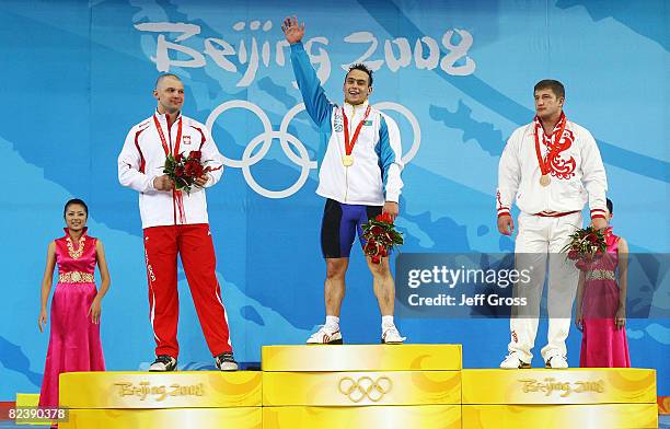 Szymon Kolecki of Poland, silver, Ilya Ilin of Kazakhstan, gold, Arsen Kasabiev of Georgia, bronze, receive their medals after winning the men's 94kg...