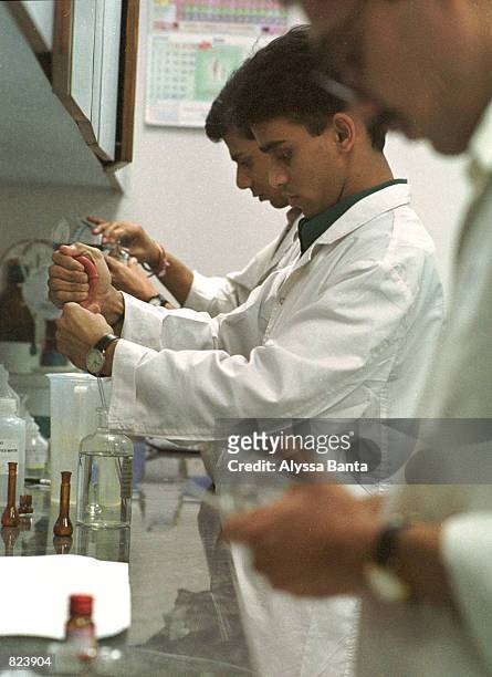 Scientists test drugs at the Quality Control Department of the Cipla research and development facility February 18, 2001 in Bombay, India. The...