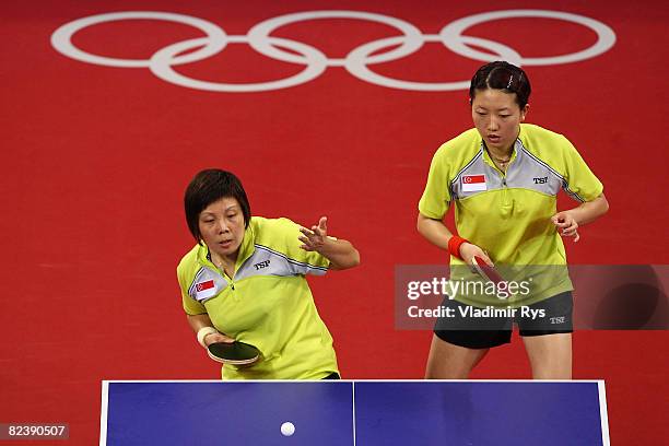 Yue Gu Wang and Jia Wei Li of Singapore play against Yue Guo and Yining Zhang of China in the table tennis event held at the Peking University...