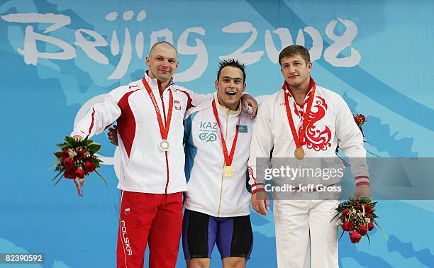 Szymon Kolecki of Poland, silver, Ilya Ilin of Kazakhstan, gold, Arsen Kasabiev of Georgia, bronze, receive their medals after winning the men's 94kg...