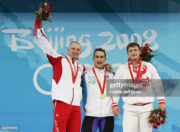 Szymon Kolecki of Poland, silver, Ilya Ilin of Kazakhstan, gold, Arsen Kasabiev of Georgia, bronze, receive their medals after winning the men's 94kg...