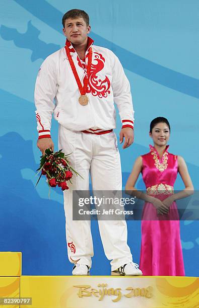 Arsen Kasabiev of Georgia receives his bronze medal after the men's 94kg weightlifting event held at the Beijing University of Aeronautics &...